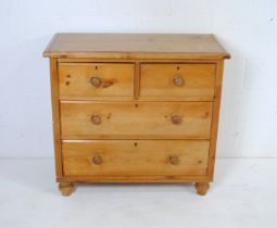 An antique pine chest of four drawers, raised on turned feet - length 92cm, depth 45cm, height 84cm