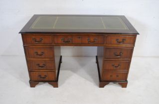 A mahogany kneehole writing desk, with green leather inset top - one handle loose but present -