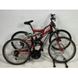 Two "youth" size mountain bikes. An Apollo (black) FS24 18 Speed bike with suspension frame and