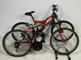 Two "youth" size mountain bikes. An Apollo (black) FS24 18 Speed bike with suspension frame and