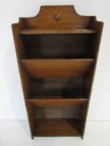 A small freestanding oak book/magazine rack