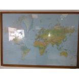 A large framed map of the world dated 1983