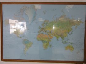 A large framed map of the world dated 1983