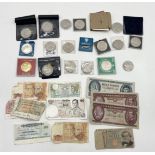 A collection of various commemorative crowns and banknotes