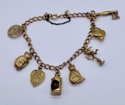 A 9ct gold charm bracelet with a collection of charms attached, total weight 15g