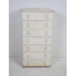 A white painted chest of seven drawers, raised on bun feet - length 60cm, depth 41cm, height 117cm