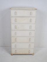 A white painted chest of seven drawers, raised on bun feet - length 60cm, depth 41cm, height 117cm