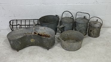 A collection of weathered galvanised including watering cans, seed lip, bucket, tin bath etc
