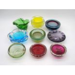 A collection of nine art glass dishes and ash trays, including a Bohemian Czech yellow vase,