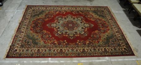 A red ground traditional Eastern style carpet - 9ft x 12ft