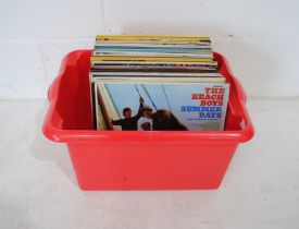 A collection of mostly 60's 12" vinyl records, including The Beach Boys, The Monkees, The Walker