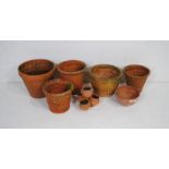 A quantity of various sized terracotta garden pots