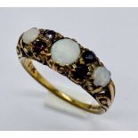 A Victorian 9ct gold ring set with opals and garnets