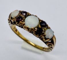 A Victorian 9ct gold ring set with opals and garnets
