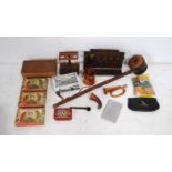 A collection of smoking related items, including pipe racks, ceramic tobacco box, cigarette case