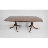 A turn of the century Regency style mahogany extending dining table with one leaf - total length