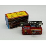 A vintage boxed Yone Tinplate Mechanical Fire Engine with self-extending ladder,