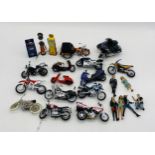 A small collection of unboxed die-cast and plastic motorcycles and bikes, along with two petrol