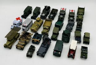 A collection of unboxed military die-cast vehicles including trucks, land rover, ambulances,