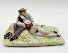 An erotic figure group of a reclining couple