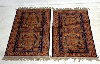 Two small matching Eastern style rugs. 116cm X 69cm