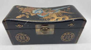 A Chinese lacquered box in the form of a pillow