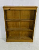 A pine freestanding bookcase - height 104cm, depth 20cm, width 84cm