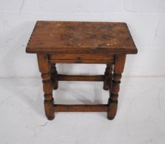 An oak joint stool, with turned supports