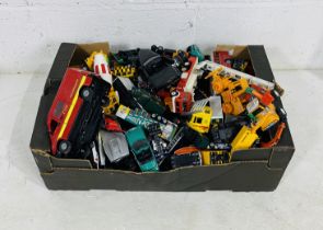 A collection of unboxed die-cast and plastic toy vehicles including cranes, emergency vehicles, skip