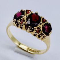 A 9ct gold garnet three stone ring