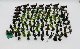 A collection of plastic military army soldiers toy figurines (some with metal bases) including