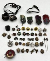 A collection of early Boy Scouts badges including enamelled service pins, four silver hat badges