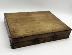 A vintage wooden artist's box with interior metal tray