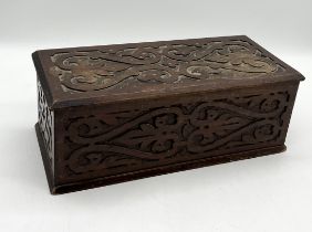 A vintage wooden box with carved detail