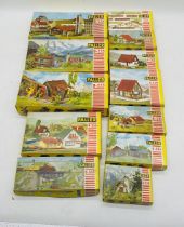 A collection of twelve boxed Faller model railway buildings and bridges model kits