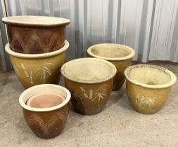 A collection of 7 ceramic plant pots
