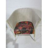 A Lloyd Loom "Lusty" armchair with label to underside