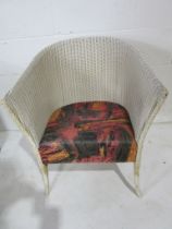 A Lloyd Loom "Lusty" armchair with label to underside