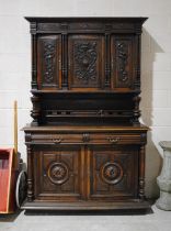 A large turn of the century French heavily carved oak cupboard - length 140cm, depth 51cm, height