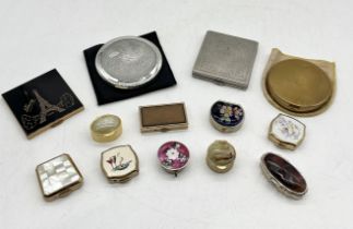 A collection of vintage compacts and pill pots