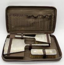 A cased hallmarked silver Art Deco dressing table set