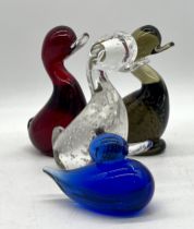 Three Whitefriars glass dilly ducks plus one Jaffe Rose blue glass duck.