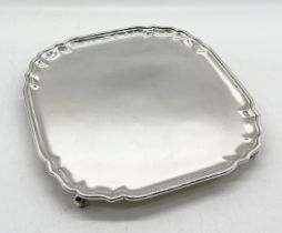 An Edwardian hallmarked silver salver on four scroll feet, weight 1048.7g (34.62 troy ounces)