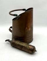 A vintage Pyrene fire extinguisher along with a vintage coal scuttle.