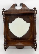 An Edwardian wall hanging shield shaped mirror in inlaid mahogany surround