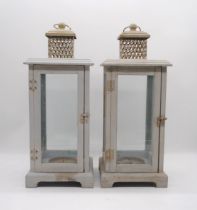 A pair of painted wooden candle lanterns