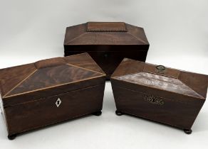 A collection of three antique tea caddys of sarcophagus shape and raised on bun feet