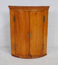 A Georgian pine bow fronted corner cupboard - length 72cm, height 93cm