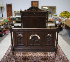 A French Breton heavily carved double bed - width 146cm, height 155.5cm