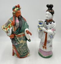 Two large Chinese porcelain figures of a warrior and lady holding a vase - height 41cm